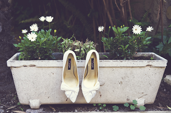 bride's shoes hanging from flower pot - wedding photo by top Rome based destination wedding photographer Rochelle Cheever, Rome Weddings Photography